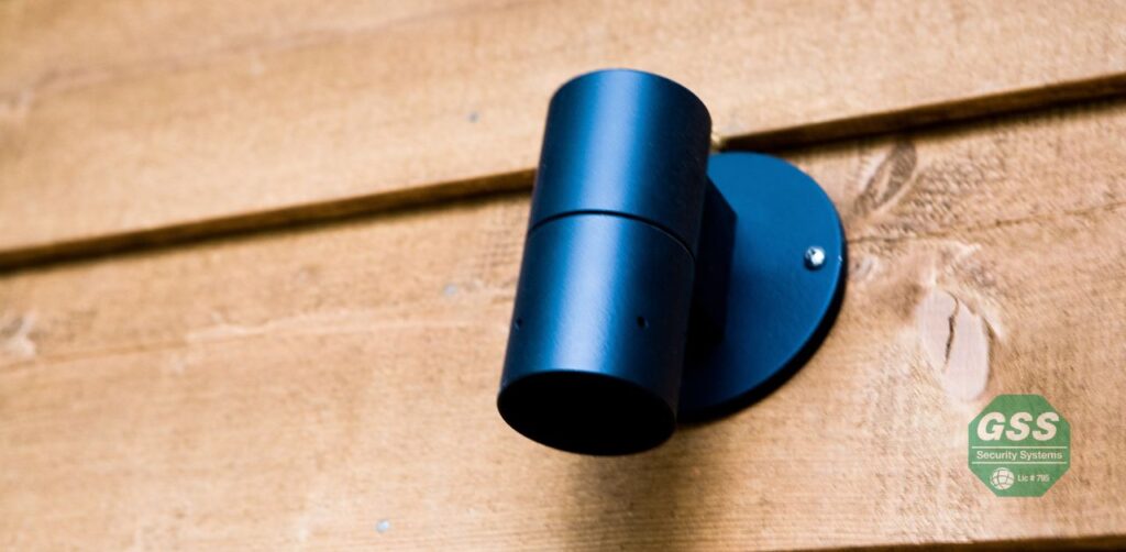 An outdoor light with a motion sensor illuminating a front yard