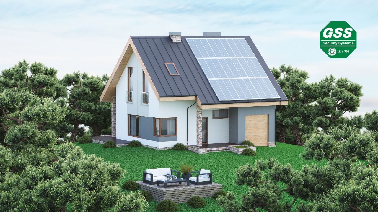 Modern eco-friendly house surrounded by trees, featuring solar panels on the roof and an outdoor seating area, promoting sustainable living.