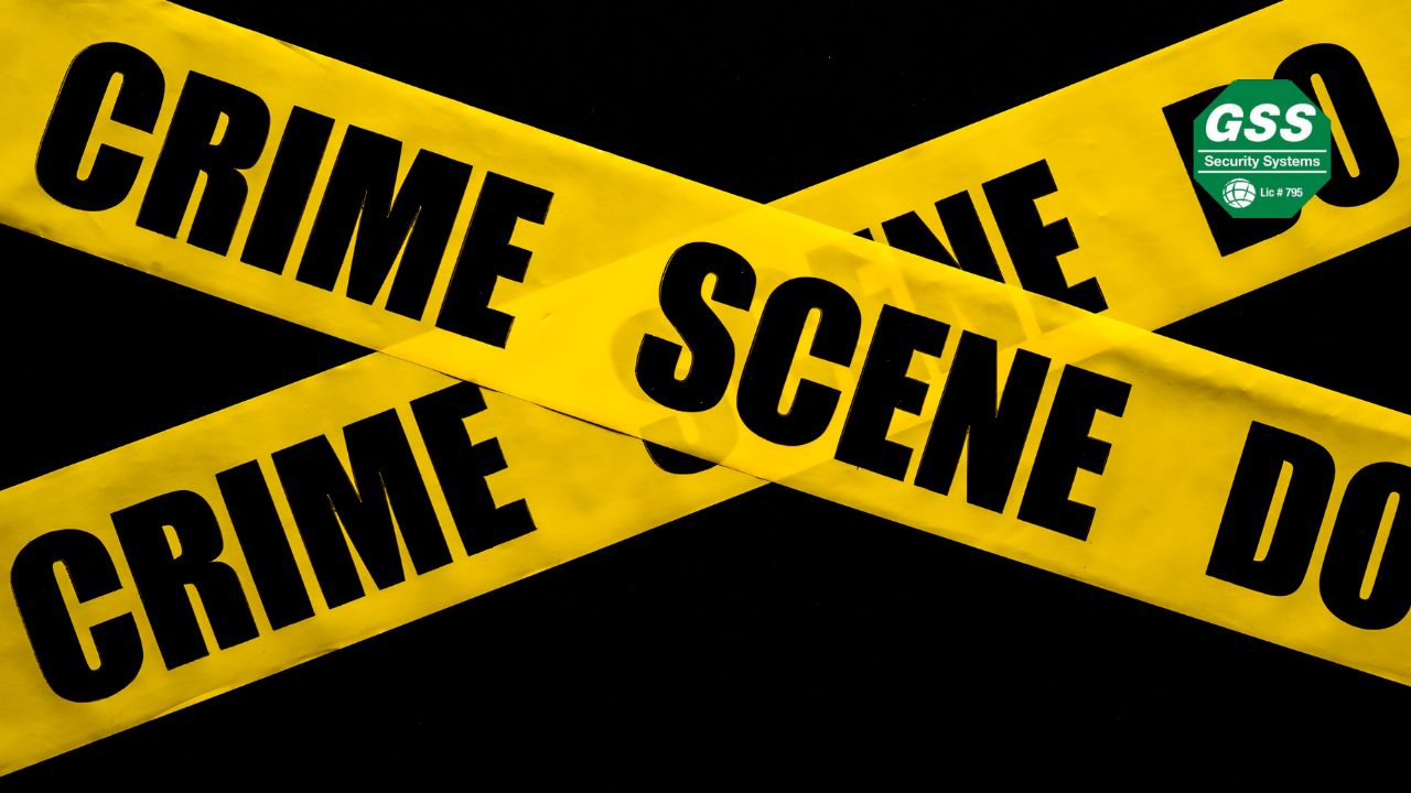 "Yellow crime scene tape crossed against a dark background, creating a stark and attention-grabbing visual. The GSS Security Systems logo is displayed in the top right corner, emphasizing the importance of crime awareness and security solutions for homes and businesses.