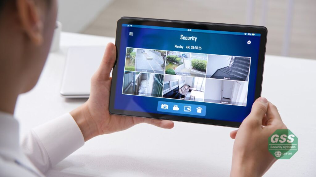 Homeowner using smartphone to monitor home security system