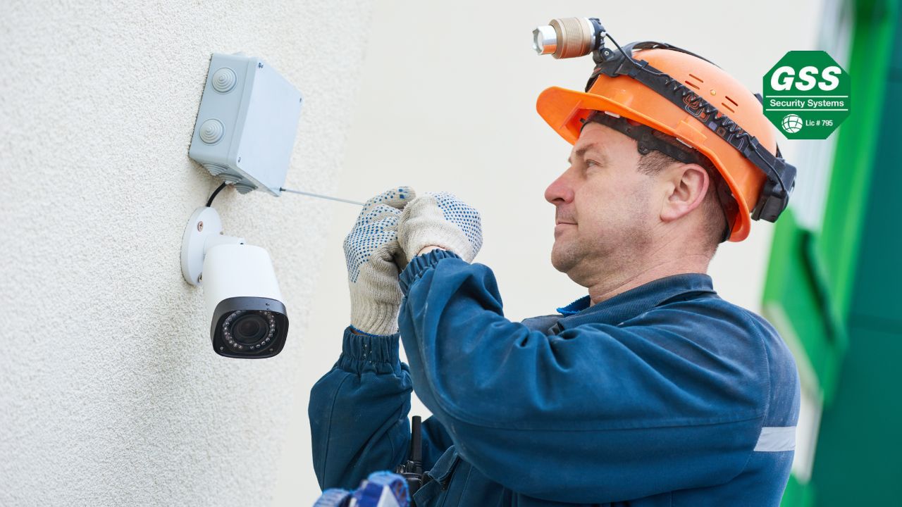 security technician installing a modern CCTV camera on a wall, symbolizing advancements in AI-powered surveillance technology.